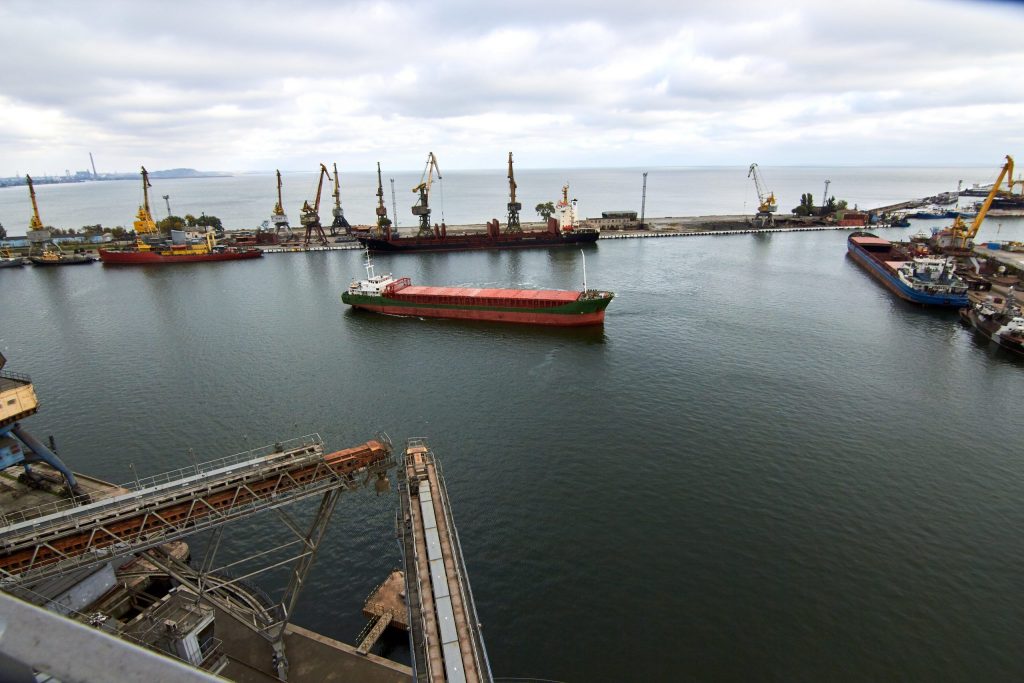 bulk-ship-enters-harbour-of-commercial-dock-at-seaport-to-load-at-grain-terminal-wheat-elevators-scaled