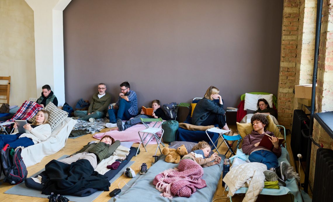 Group of refugees using mobile gadgets